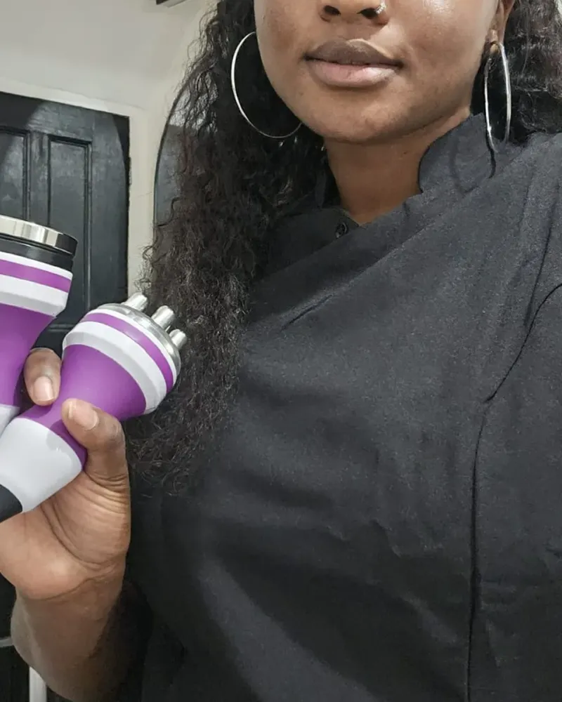 Toyin (Wumi) holding the ultrasonic cavitation and radio frequency handpieces she uses for body sculpting at her Dartford studio